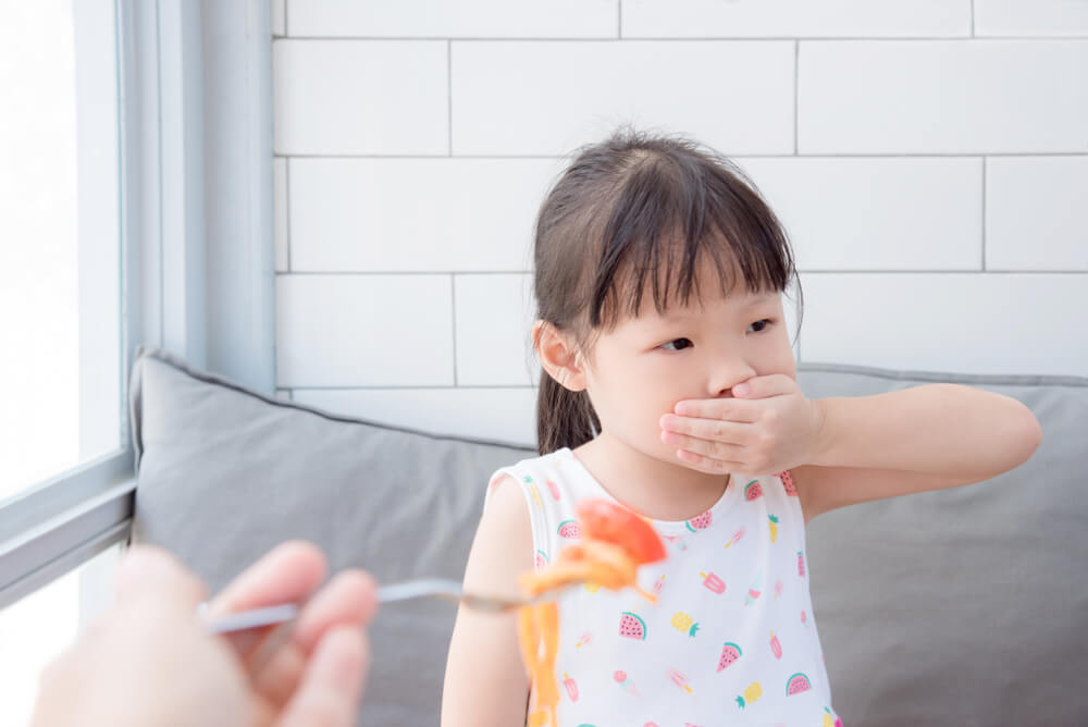 Little Asian Girl Close Her Mouth by Hand Refuse to Eat Tomato in Spaghetti From Her Mother